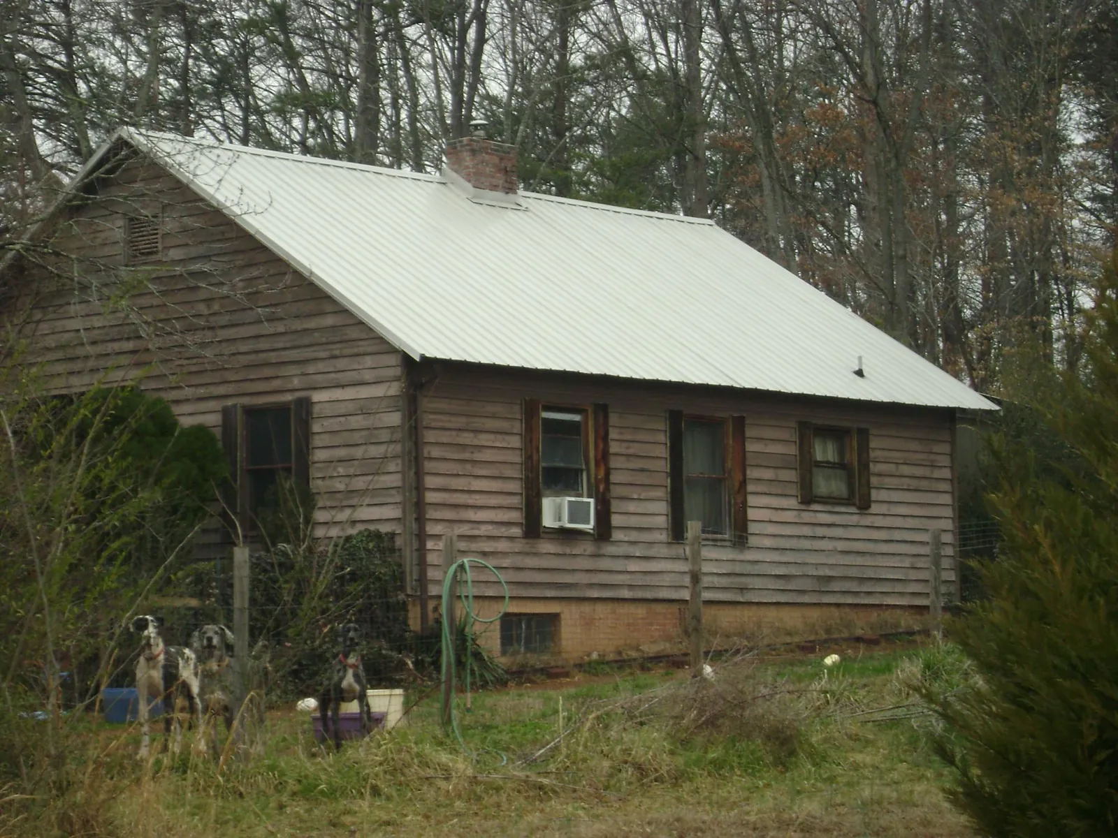White metal roof on an old wood sided farmhouse, from a Metal Roof Installation job in Loris